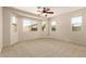 Spacious carpeted bedroom offering many bright windows and natural light at 17493 N Costa Brava Ave, Maricopa, AZ 85139