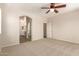 Large bedroom with carpet, a ceiling fan, and an ensuite bathroom at 17493 N Costa Brava Ave, Maricopa, AZ 85139
