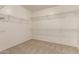 Spacious walk-in closet featuring neutral carpeting and white wire shelving for ample storage at 17493 N Costa Brava Ave, Maricopa, AZ 85139