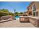 Inviting backyard featuring an outdoor kitchen, pool, and mature landscaping perfect for entertaining at 1751 W Mulberry Dr, Chandler, AZ 85286