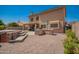 Spacious backyard featuring an outdoor kitchen, covered patio, pool, and spa; ideal for relaxation and entertainment at 1751 W Mulberry Dr, Chandler, AZ 85286