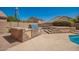 Outdoor kitchen and grill area with stone accents in a spacious backyard, perfect for entertaining at 1751 W Mulberry Dr, Chandler, AZ 85286