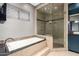 This bathroom showcases a luxurious tub and shower combo with a stylish tile surround at 1751 W Mulberry Dr, Chandler, AZ 85286