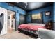 This cozy bedroom features blue walls, a ceiling fan, and a window with neighborhood views at 1751 W Mulberry Dr, Chandler, AZ 85286