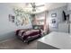 Comfortable bedroom featuring light walls, bed with patterned bedding, and a well-lit study area at 1751 W Mulberry Dr, Chandler, AZ 85286