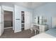 This bedroom features a vanity table with lighting, a bed, and closet access at 1751 W Mulberry Dr, Chandler, AZ 85286