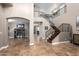 Open-concept foyer with staircase, travertine floors, and views into other living spaces at 1751 W Mulberry Dr, Chandler, AZ 85286