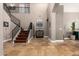 Grand foyer with high ceilings, travertine floors, staircase with iron railings, and a view of the upper level at 1751 W Mulberry Dr, Chandler, AZ 85286