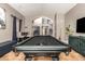 Game room with a black pool table, travertine floors, and views to a staircase and the front of the house at 1751 W Mulberry Dr, Chandler, AZ 85286