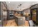 Modern kitchen with stainless steel appliances, island with granite countertops, and wine cooler at 1751 W Mulberry Dr, Chandler, AZ 85286