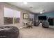 Spacious living room with dual ceiling fans, large windows, and a comfortable seating area at 1751 W Mulberry Dr, Chandler, AZ 85286