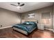 This main bedroom features a ceiling fan, a cozy bed, and a matching nightstand on hardwood floors at 1751 W Mulberry Dr, Chandler, AZ 85286