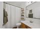 Well-lit bathroom featuring a modern vanity, decorative shelves, and a stylish mirror at 1812 E Parkside E Ln, Phoenix, AZ 85024