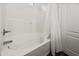 Bright white bathroom featuring a tub and shower combination with tile surround and chrome fixtures at 1812 E Parkside E Ln, Phoenix, AZ 85024