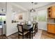 Dining room features a modern light fixture and is open to the living area at 1812 E Parkside E Ln, Phoenix, AZ 85024