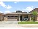 Charming single-Gathering home featuring a well-manicured lawn, a two-car garage, and desert-friendly landscaping at 1812 E Parkside E Ln, Phoenix, AZ 85024