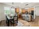 Open concept kitchen and dining room featuring stainless appliances and an island with barstool seating at 1812 E Parkside E Ln, Phoenix, AZ 85024