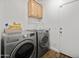 Functional laundry room with a washer and dryer, storage cabinets, and ample space at 1812 E Parkside E Ln, Phoenix, AZ 85024