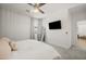 This bedroom features a ceiling fan, carpeted floors, and a wall-mounted television for entertainment at 1812 E Parkside E Ln, Phoenix, AZ 85024