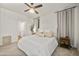 Well-lit primary bedroom featuring a ceiling fan, carpeted floor, and soothing neutral color palette at 1812 E Parkside E Ln, Phoenix, AZ 85024