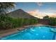 Inviting pool with a beautiful water feature and desert landscaping, set against a scenic mountain backdrop at 1812 E Parkside E Ln, Phoenix, AZ 85024