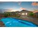 Backyard with inviting pool, patio seating, and desert landscaping, perfect for outdoor relaxation and entertainment at 1812 E Parkside E Ln, Phoenix, AZ 85024