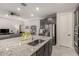 A kitchen island with granite counters overlooks the living area with stainless appliances and a double oven at 18368 W Long Lake Rd, Goodyear, AZ 85338