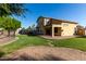 Well-maintained backyard with a covered patio, brick pavers, and a grassy area for relaxation at 1918 E Megan St, Gilbert, AZ 85295