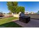 Backyard with a shed, hot tub, and paved area, offering space for storage and outdoor leisure at 1918 E Megan St, Gilbert, AZ 85295