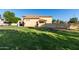 Expansive backyard featuring lush green grass and a covered patio, perfect for outdoor living at 1918 E Megan St, Gilbert, AZ 85295