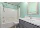 Bathroom features a white tiled shower, gray vanity, and modern fixtures at 1918 E Megan St, Gilbert, AZ 85295