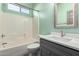 Bathroom features a white tiled shower, gray vanity, and modern fixtures at 1918 E Megan St, Gilbert, AZ 85295