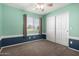 Bedroom featuring two-tone paint, carpeted floors, a ceiling fan, and closet doors at 1918 E Megan St, Gilbert, AZ 85295