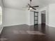 Spacious bedroom featuring wood floors, ceiling fan, and stylish sliding door at 1918 E Megan St, Gilbert, AZ 85295