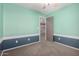 Bedroom with two-tone paint, carpeted floors, a ceiling fan, and interior door at 1918 E Megan St, Gilbert, AZ 85295