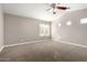 Spacious bedroom with a vaulted ceiling, ceiling fan, and large windows that provide natural light at 1918 E Megan St, Gilbert, AZ 85295