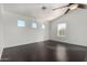 Light and bright bedroom with hardwood floors, ceiling fan, and three large windows at 1918 E Megan St, Gilbert, AZ 85295