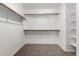Walk-in closet featuring carpeted floors, white walls, and wood shelving at 1918 E Megan St, Gilbert, AZ 85295