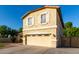 Inviting two-story home featuring a manicured lawn, charming front porch, and attached two-car garage at 1918 E Megan St, Gilbert, AZ 85295