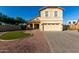 Inviting two-story home featuring a manicured lawn, charming front porch, and attached two-car garage at 1918 E Megan St, Gilbert, AZ 85295