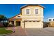 Inviting two-story home featuring a manicured lawn, charming front porch, and attached two-car garage at 1918 E Megan St, Gilbert, AZ 85295