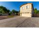 Inviting two-story home featuring a manicured lawn, charming front porch, and attached two-car garage at 1918 E Megan St, Gilbert, AZ 85295