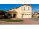 Inviting two-story home featuring a manicured lawn, charming front porch, and attached two-car garage at 1918 E Megan St, Gilbert, AZ 85295