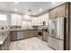 Modern kitchen featuring stainless steel appliances, granite countertops, tile backsplash, and neutral colored cabinetry at 1918 E Megan St, Gilbert, AZ 85295