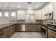 Modern kitchen featuring stainless steel appliances, granite countertops, tile backsplash, and neutral colored cabinetry at 1918 E Megan St, Gilbert, AZ 85295