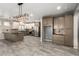 Bright open kitchen featuring granite countertops, stainless steel appliances, ample storage, and modern pendant lighting at 1918 E Megan St, Gilbert, AZ 85295
