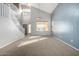 Bright living room with vaulted ceilings, neutral carpet, large windows, and a staircase at 1918 E Megan St, Gilbert, AZ 85295