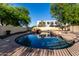 Beautiful pool area with rock features, waterfall and mature landscaping, ideal for summertime fun at 1918 E Megan St, Gilbert, AZ 85295