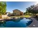 Inviting backyard pool with rock waterfall and lush greenery, perfect for cooling off on hot days at 1918 E Megan St, Gilbert, AZ 85295
