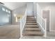 Spacious staircase, light walls, plush carpeting and tile flooring lead to upper levels at 1918 E Megan St, Gilbert, AZ 85295